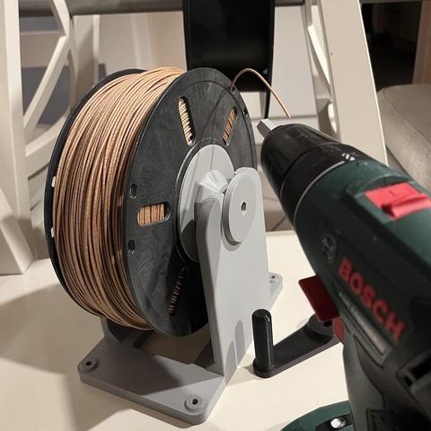 The picture shows the result, a full small spool with wood filament, next to it a cordless screwdriver that made rewinding much faster.